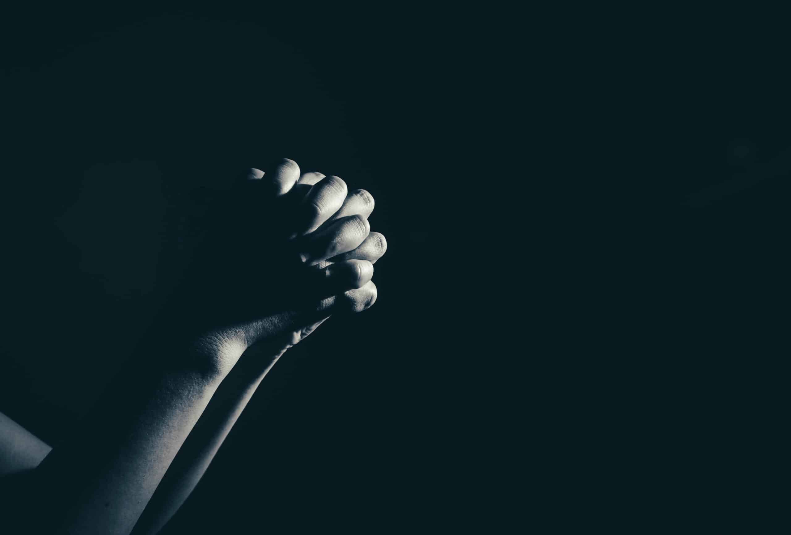 Ten Prayers for Public Schools | The Navigators Prayer Resource | clasped hands praying against a black background