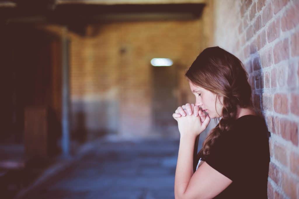 6 Ways To Break Down Spiritual Barriers The Navigators Woman Praying Against Brick Wall