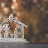 Prayers to Keep Christ in Christmas | The Navigators Prayer Resource | Ornamental nativity scene with Christmas tree background