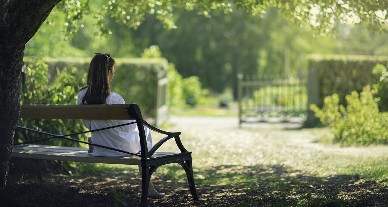 How to Have a Daily Quiet Time | The Navigators Bible Study Resources | A woman relaxing in a green garden