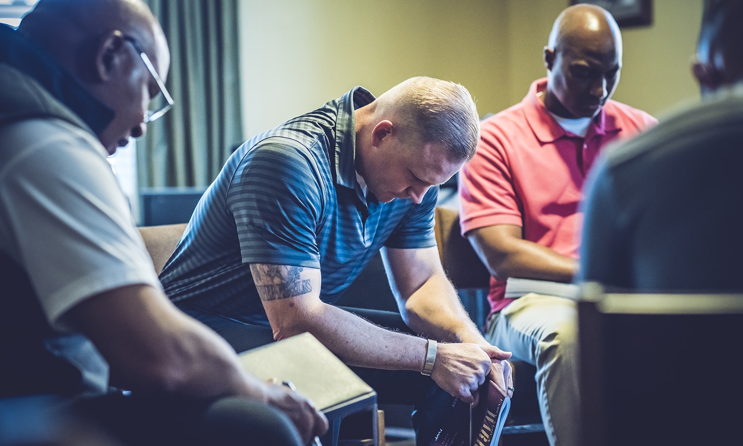 Praying for Our Troops | Navigators Prayer Resource | Military men reading the bible and praying