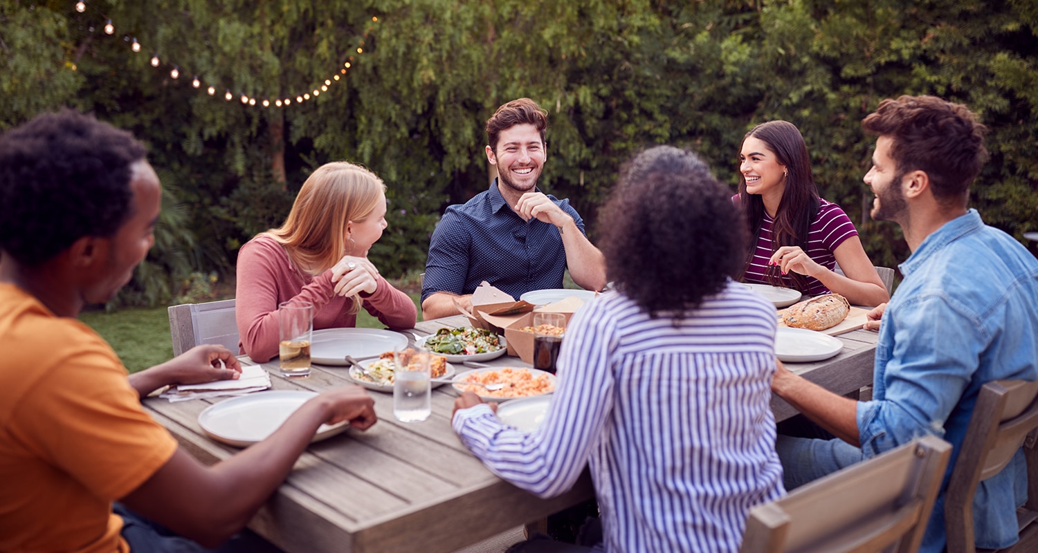 Navigators Thanksgiving Bible Study | Gratitude or Platitude | Multi-Cultural Friends At Home Sitting At Table Enjoying Food At Summer Garden Party