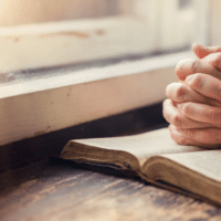 31 Days of Prayer | The Navigators Evangelism Resources | hands on a windowsill, clasped hands praying on an open bible