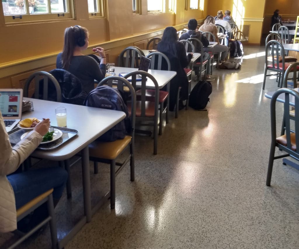 A Seat At God's Table The Navigators College students sitting in cafeteria style room alone at separate tables loneliness epidemic