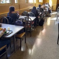 A Seat At God's Table The Navigators College students sitting in cafeteria style room alone at separate tables loneliness epidemic