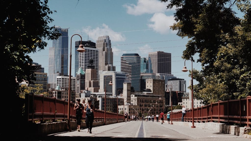 strong arch bridge Minneapolis people walking and jogging The Navigators