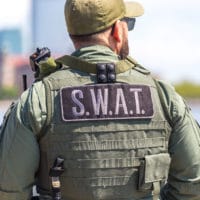 Inside the Heart of Law Enforcement: Jesus Offers Real Hope | Navigators First Responders Ministry | equipped SWAT soldier standing on a pier