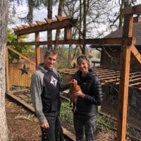 Loving Our Neighbors When We Are All At Home | Navigators Neighbors | John & Stephanie Winder posing with one of their chickens