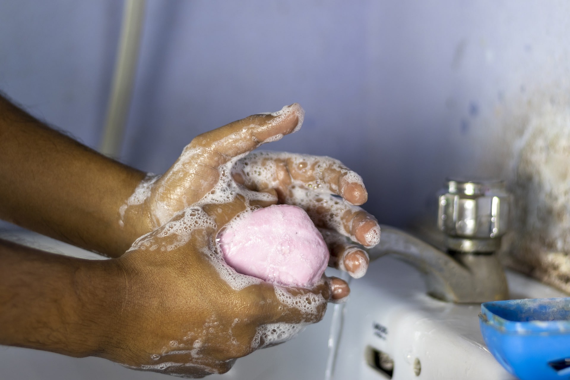 Fruitful Partnerships Advance the Gospel | Discipling for Development | man washing hands in a sink