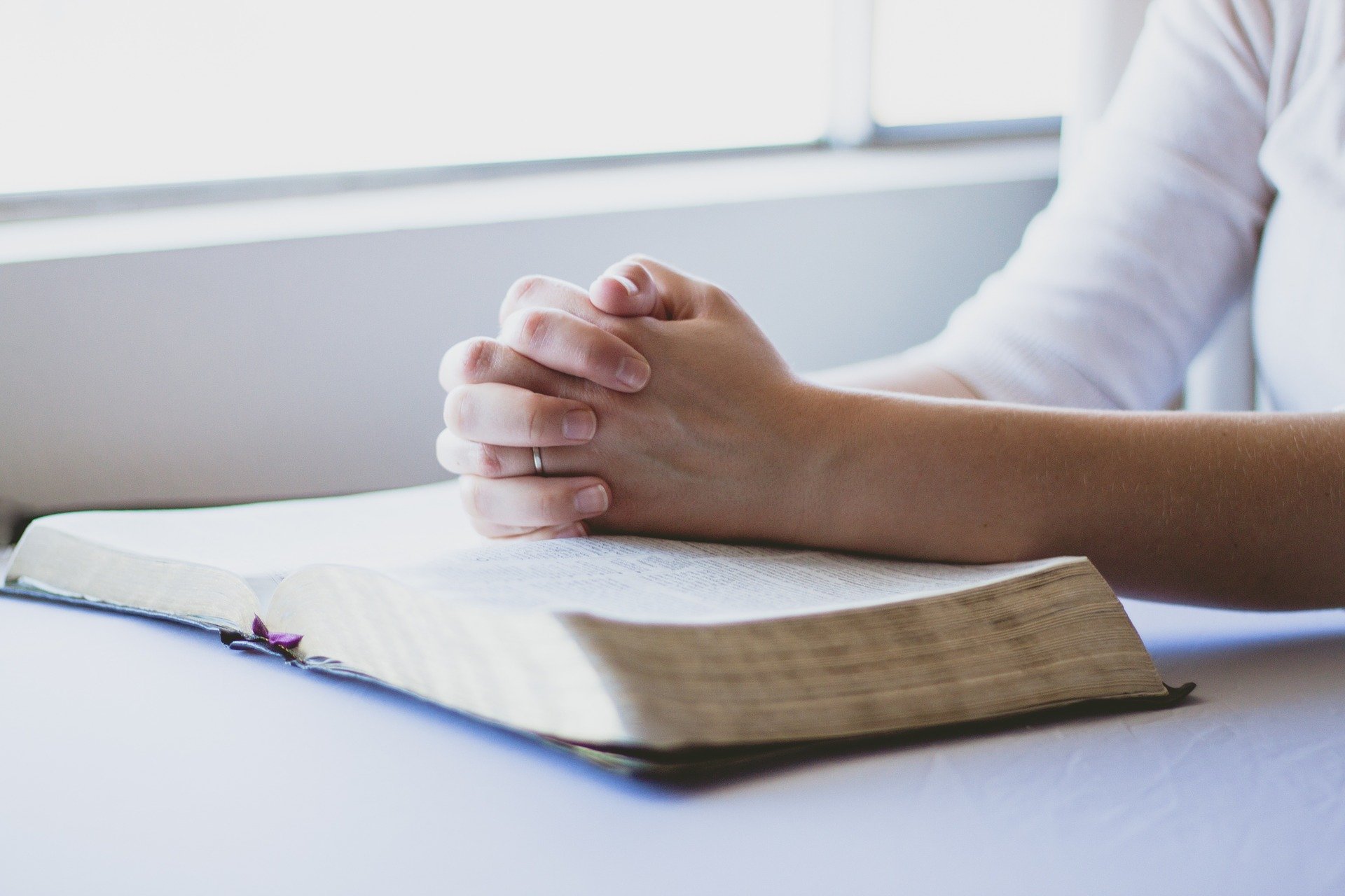 A Glorious Moment | married woman with hands folded over a Bible