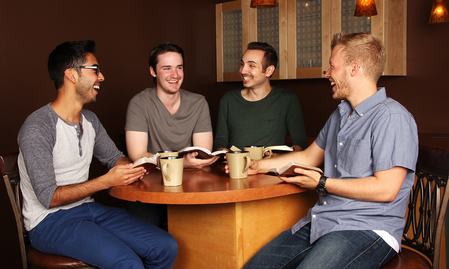 Diverse Group of Men in a Bible Study at a Cafe
