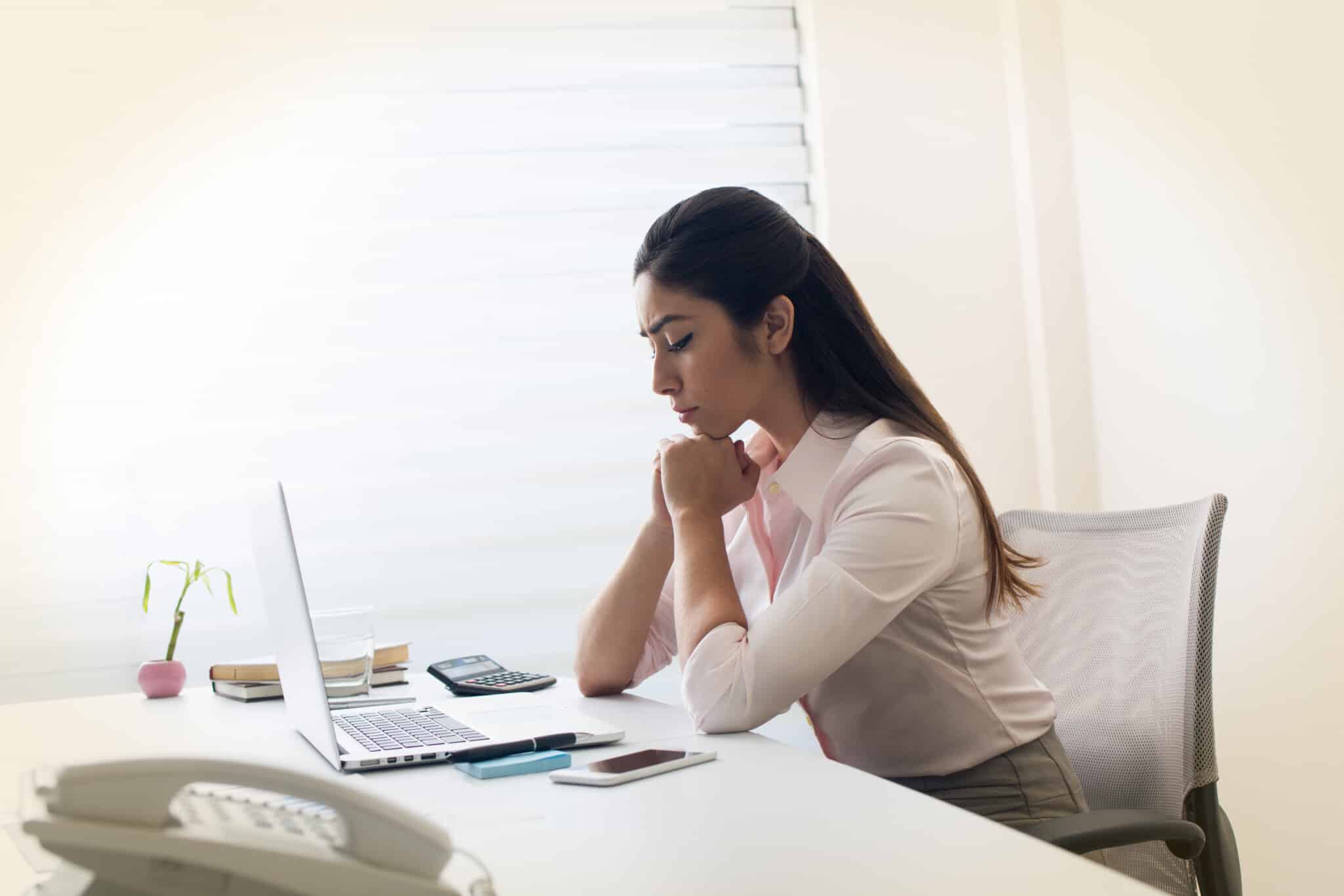 How to Pray Using the PRAY Method | Navigators Prayer Resources | Woman with clasped hands in prayer at an office desk