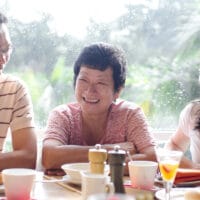 Generations of Disciples Across Decades and Miles | The Navigators International Missions | Asian young adults and senior having good time in restaurant