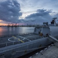 Next Door To Our Military | The Navigators Military | Part of frigate naval forces at sunset at the port