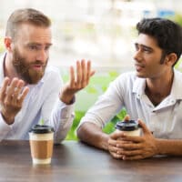 Help for Depression: How Do You Know if You're Drowning? | The Navigators Collegiate Ministry | Two male friends drinking coffee and talking in outdoor cafe