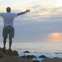 Experience the Life-Giving Love of Jesus | Navpress | Man praisng on the beach in the morning