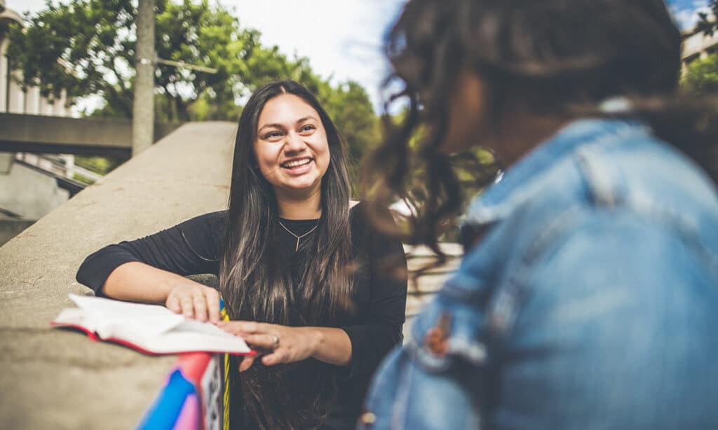 From Reading the Bible to Loving God’s Word | The Navigators Collegiate Ministry | Two women reading the bible together at college outside