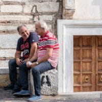 Two men friends sit and talk about discipleship.