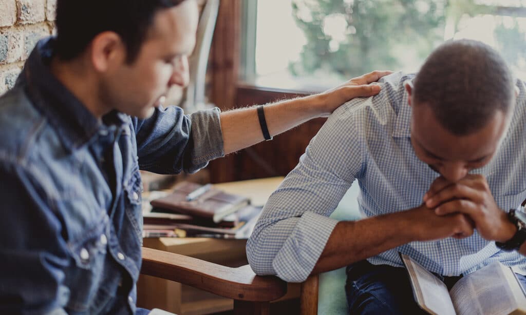 Going to the Nations From Alabama | The Navigators Military | Two men praying together