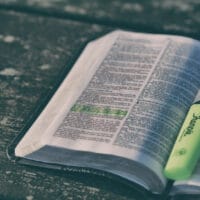 Discipleship Journal Bible Reading Plan | Navigators Bible Study Resource | Bible with a highlighter on a wooden table