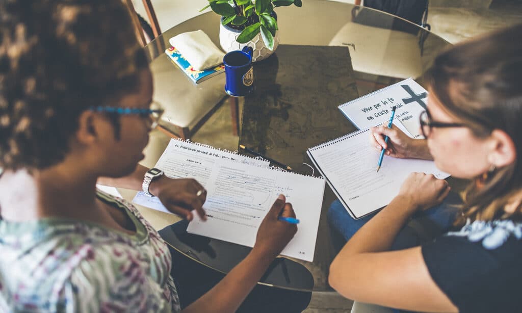 Two women do a bible study together to form a discipleship relationship.