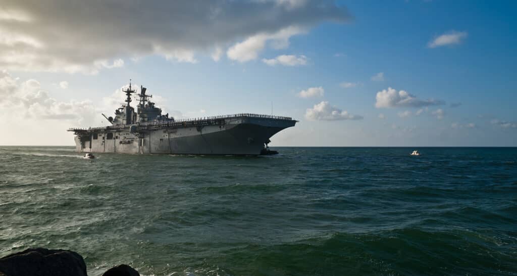 An aircraft carrier, where the Navigators Military Ministry took place, navigating through the ocean.