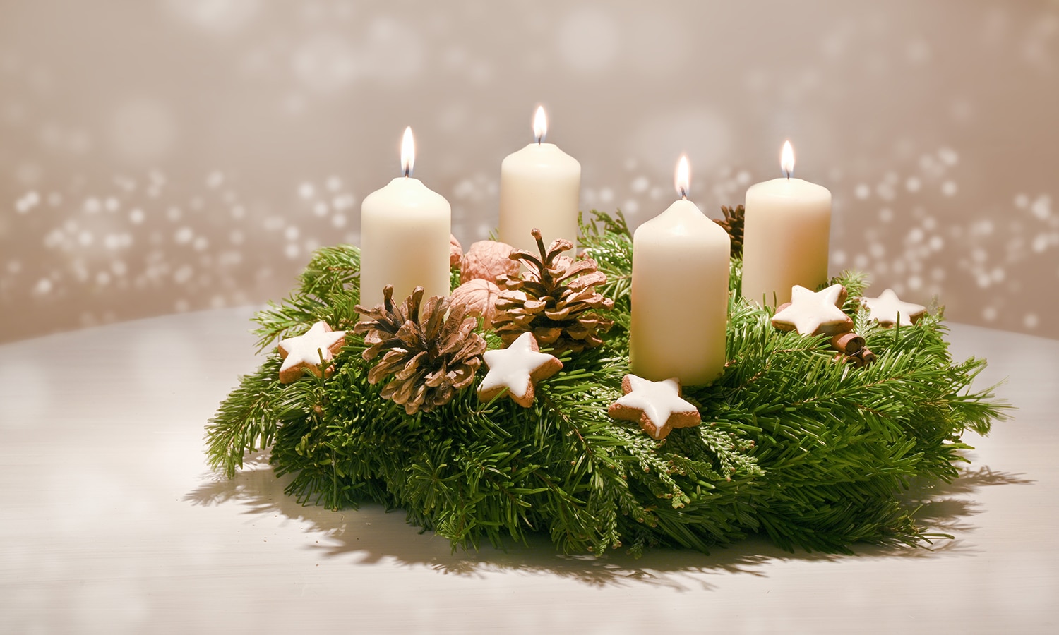 Celebrate Advent: 4 Weeks of Welcoming Jesus! | Navigators Bible Study Resource | Third Advent - decorated Advent wreath from fir and evergreen branches with white burning candles, tradition in the time before Christmas, warm background with festive bokeh and copy space