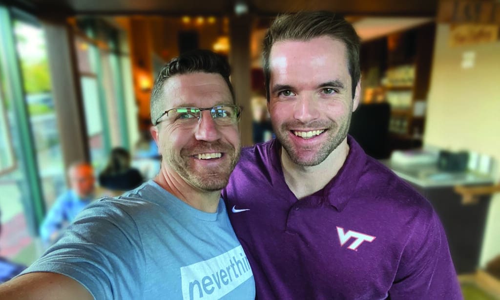 A selfie of two men from The Navigators in a restaurant.