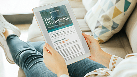 Woman reading the Daily Discipleship devotional email on an iPad