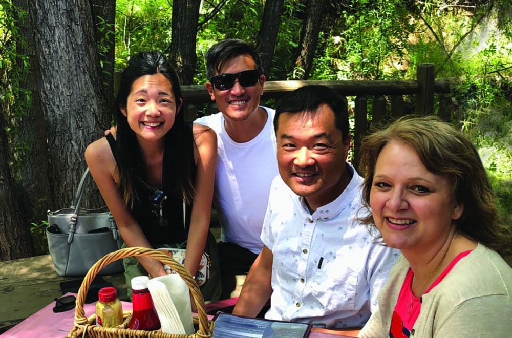 A group of Navigators enjoy a picnic outside as they fellowship together.