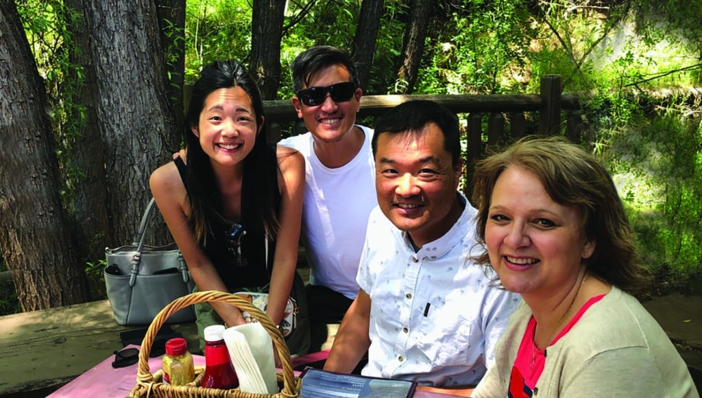 A group of Navigators enjoy a picnic outside as they fellowship together.