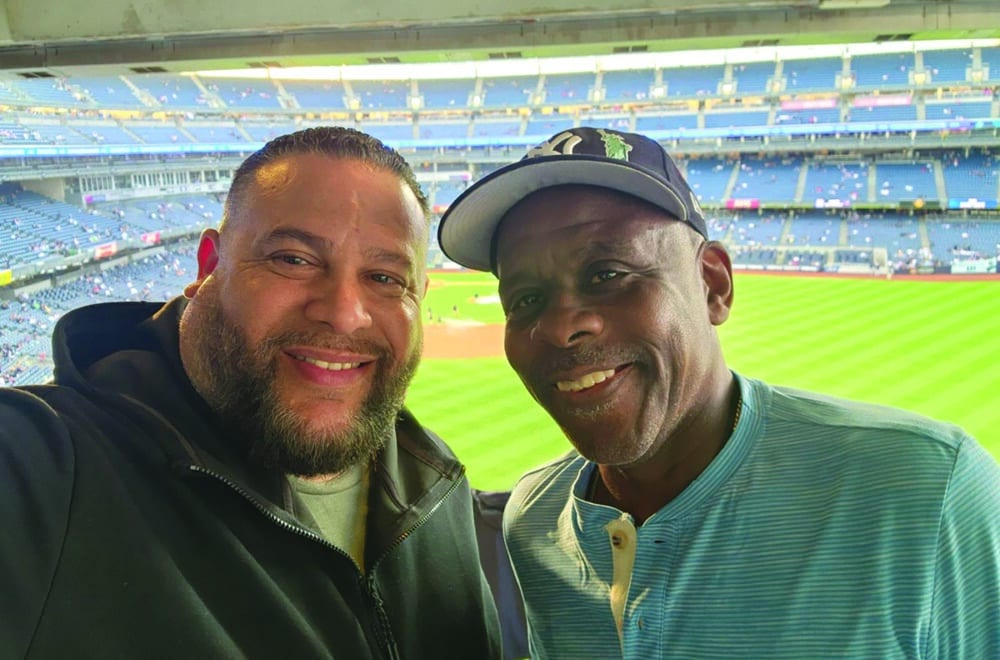 Two male co-workers enjoy a baseball game together.