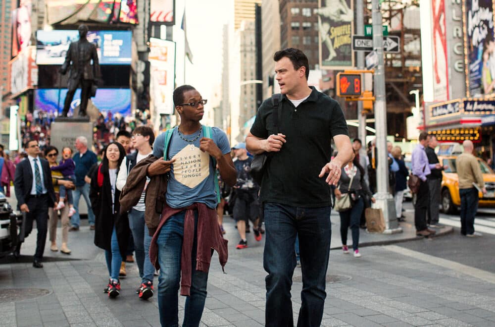 Two people walking and talking in the streets of NYC.