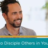 Man smiling in a home setting. There is a blue and gold banner on the bottom of the image with a caption that reads, "How to Disciple Others in Your Life"