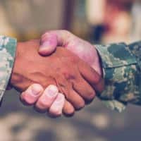 Two Male Soldiers in Military Uniform Shaking Hands