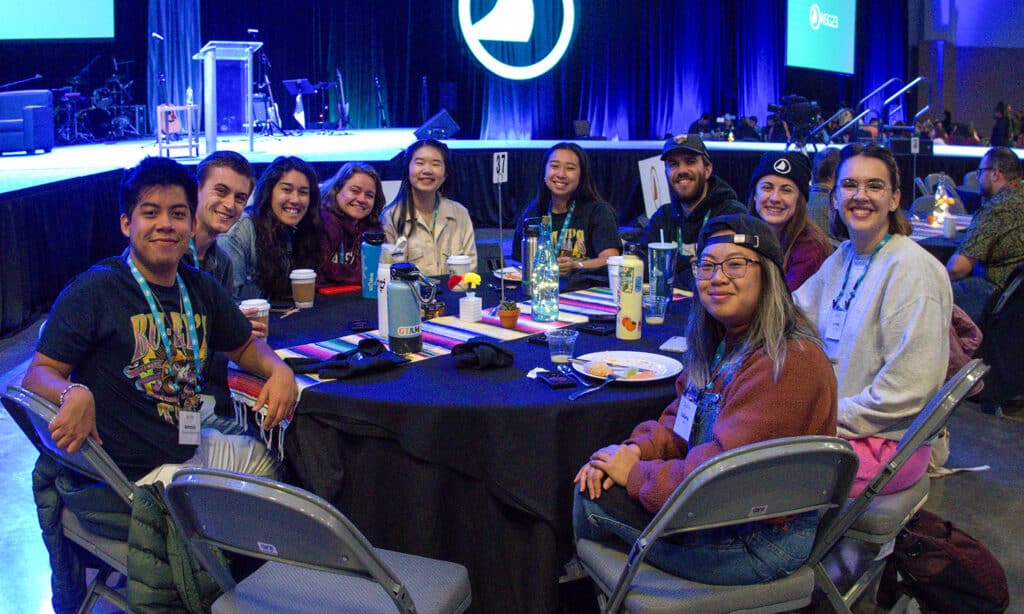 Navigators staff sit around a table at the National Staff Gathering.