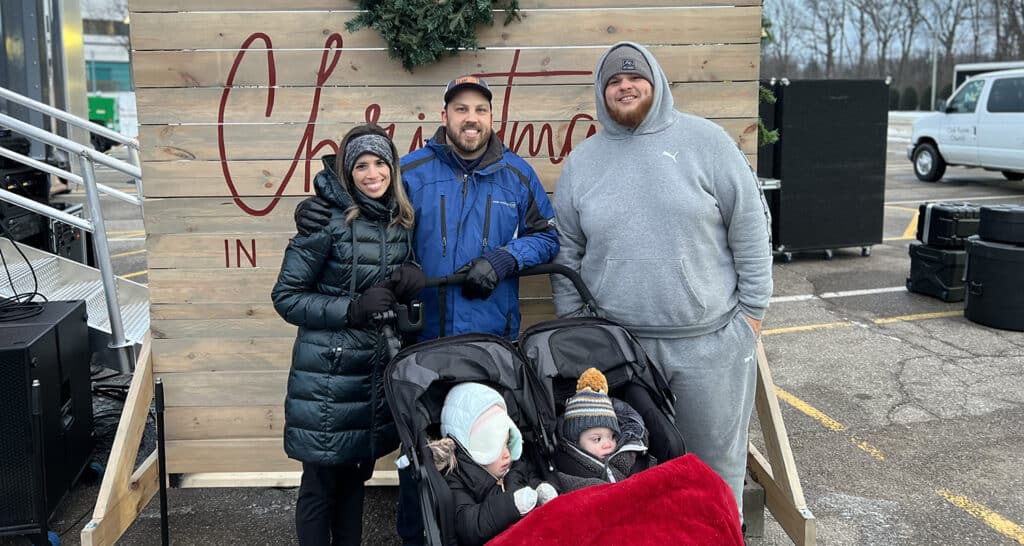 Jon and his wife and two young children stand with Matt outside.